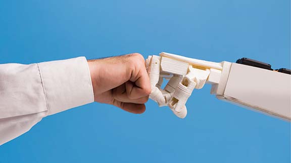 human hand bumping fist with a robot hand