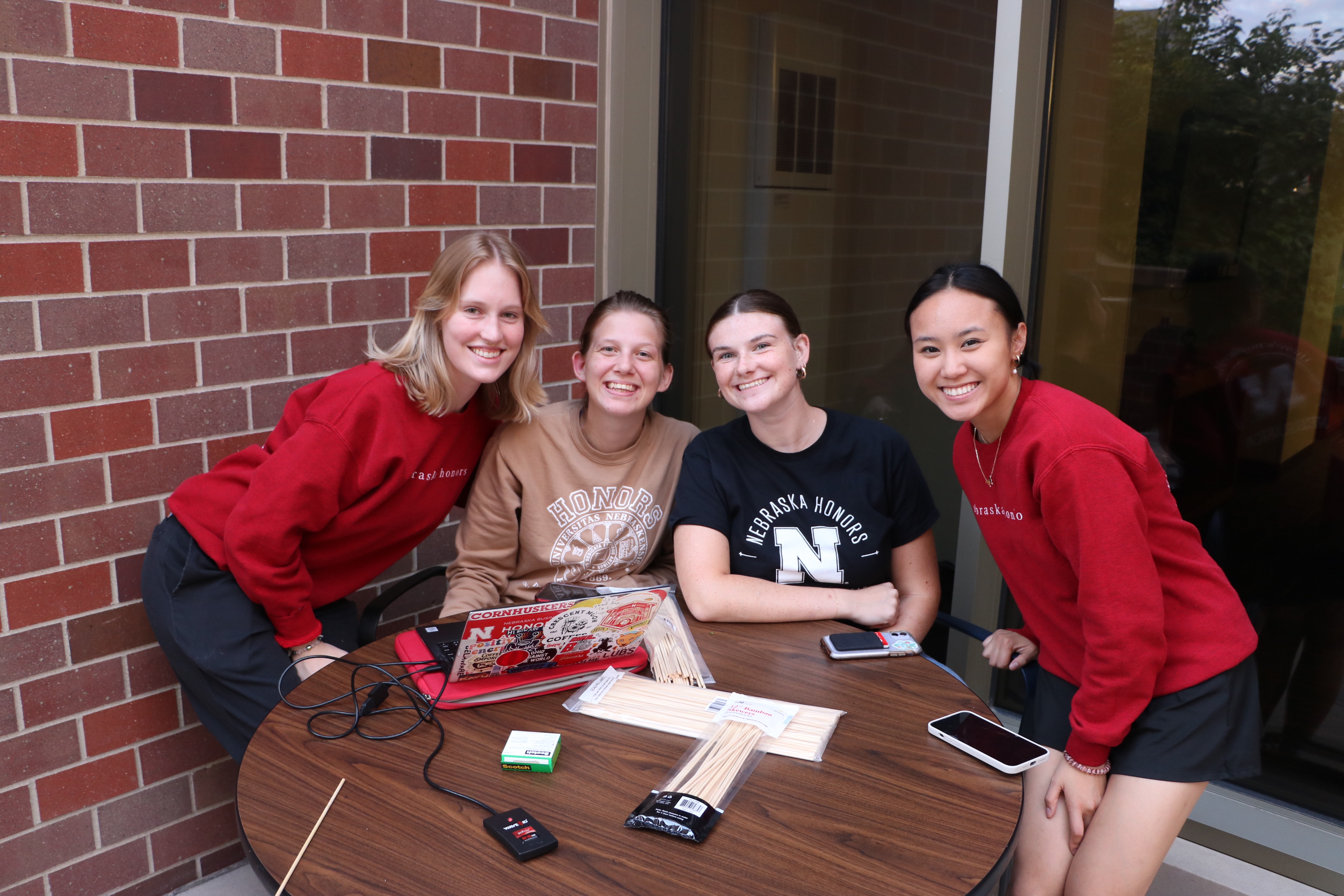 Students posing for a photo by a table