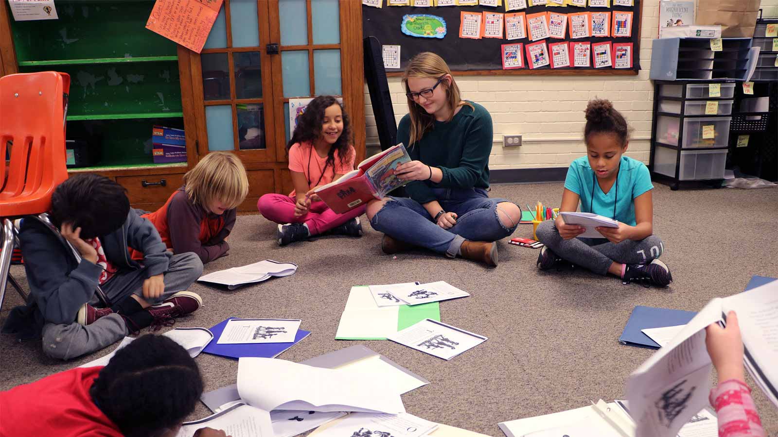 kids in afterschool club sitting on floor reading