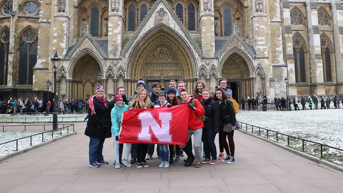 students holding N flag on oversees visit