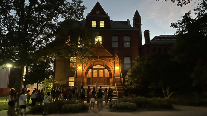 A group of students gathers at Architecture Hall to learn some of the history of the oldest building on campus.