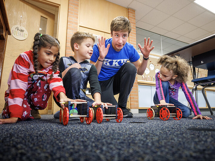 Spencer Knight gets three students and their rubber-band powered cars lined up for a race at Riley Elementary School in Lincoln.