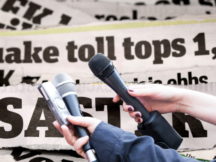 Hands holding microphones in front of headlines