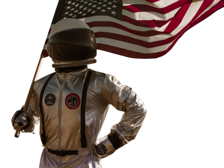 An astronaut holding an American flag