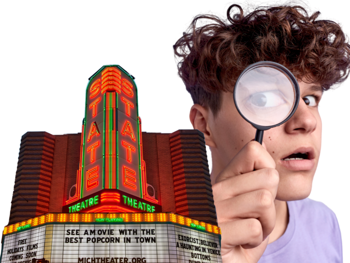 theatre marquee and man looking through magnifying glass