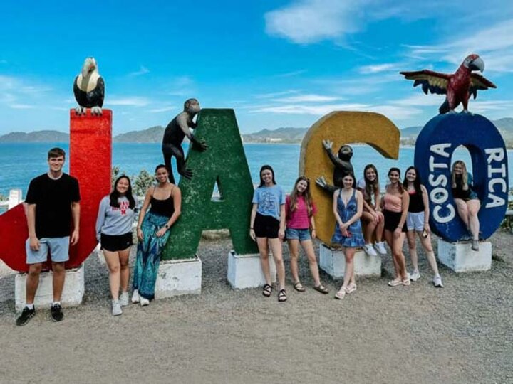 Students in Costa Rica posing by big letters