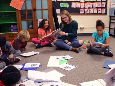 kids in afterschool club sitting on floor reading