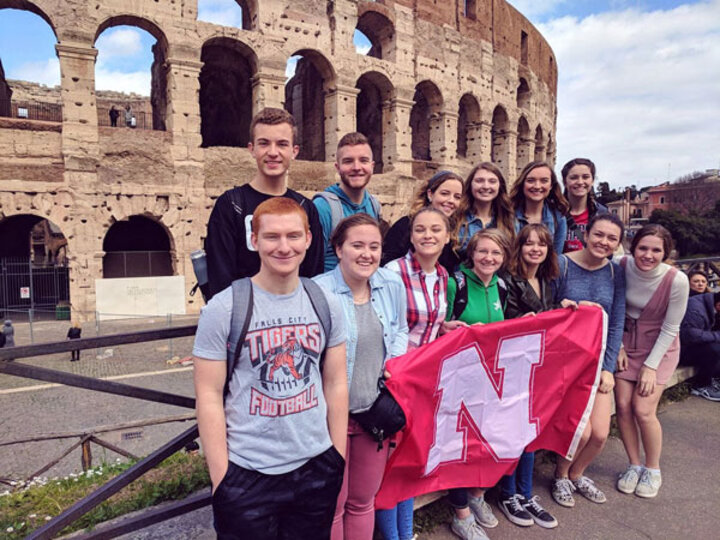 Students at colosseum with N flag
