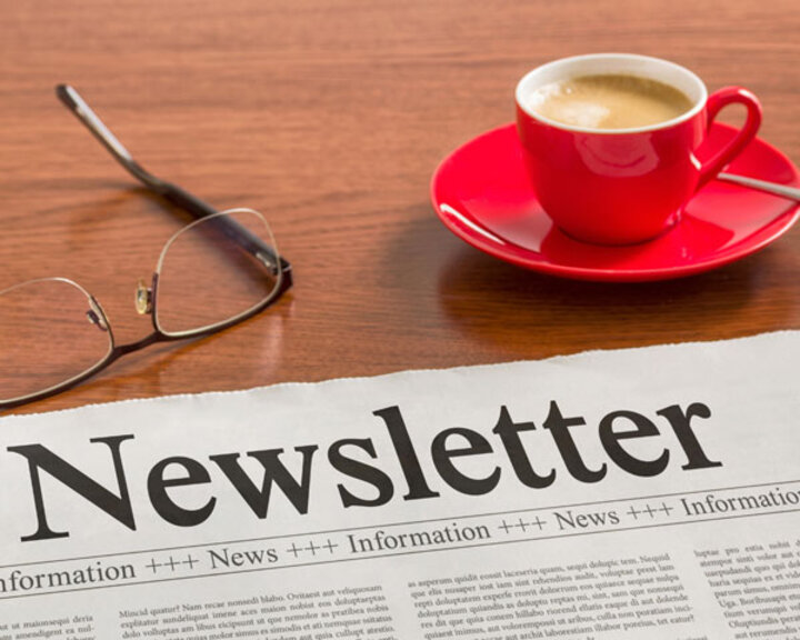 newspaper, glasses and coffee cup on table