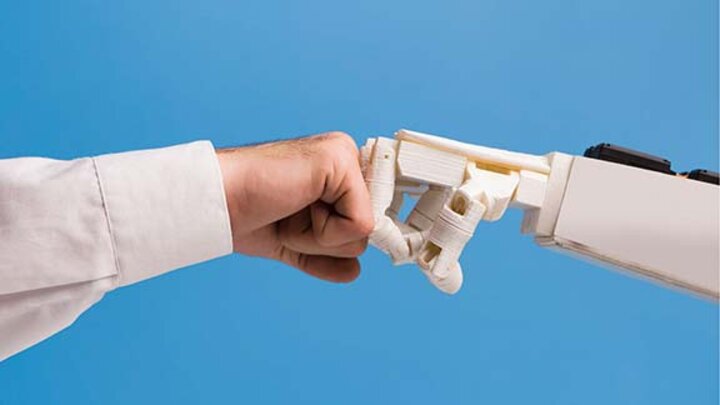 human and robot fist bumping